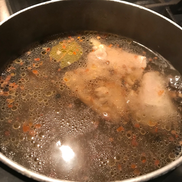 simmering chicken with aromatics