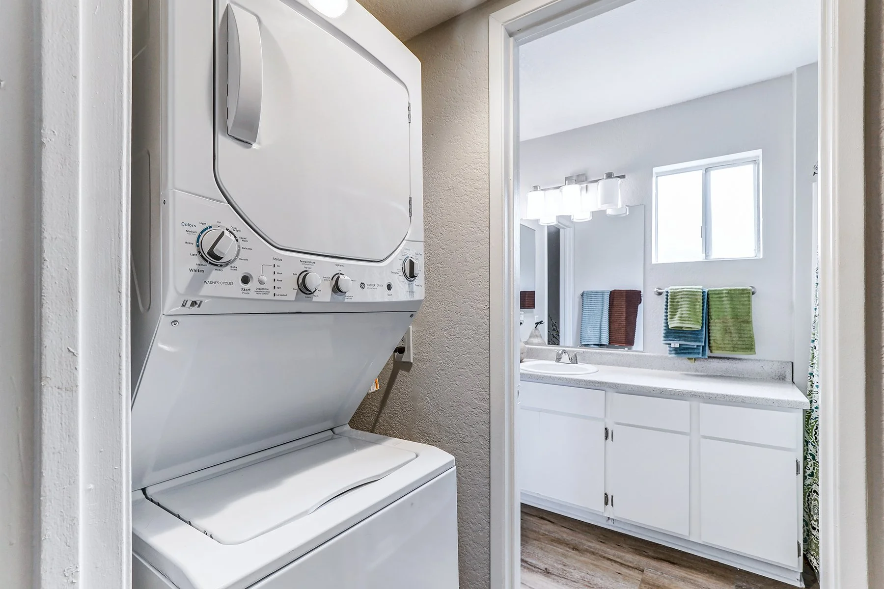 A two-bedroom model unit at Villagio, this image shows the in-unit washer/dryer