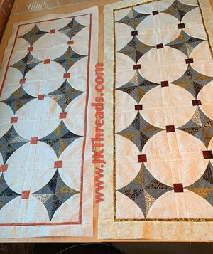 Two of the same table runners using a charm pack of 5” squares, a bit of black essex linen and my quick curve ruler mini by Sew Kind of Wonderful
