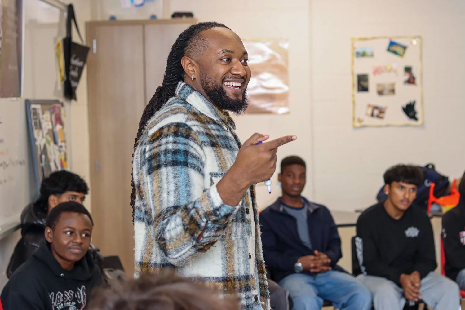 A Tune In Foundation mentor facilitates a conversation with seated youth participants.