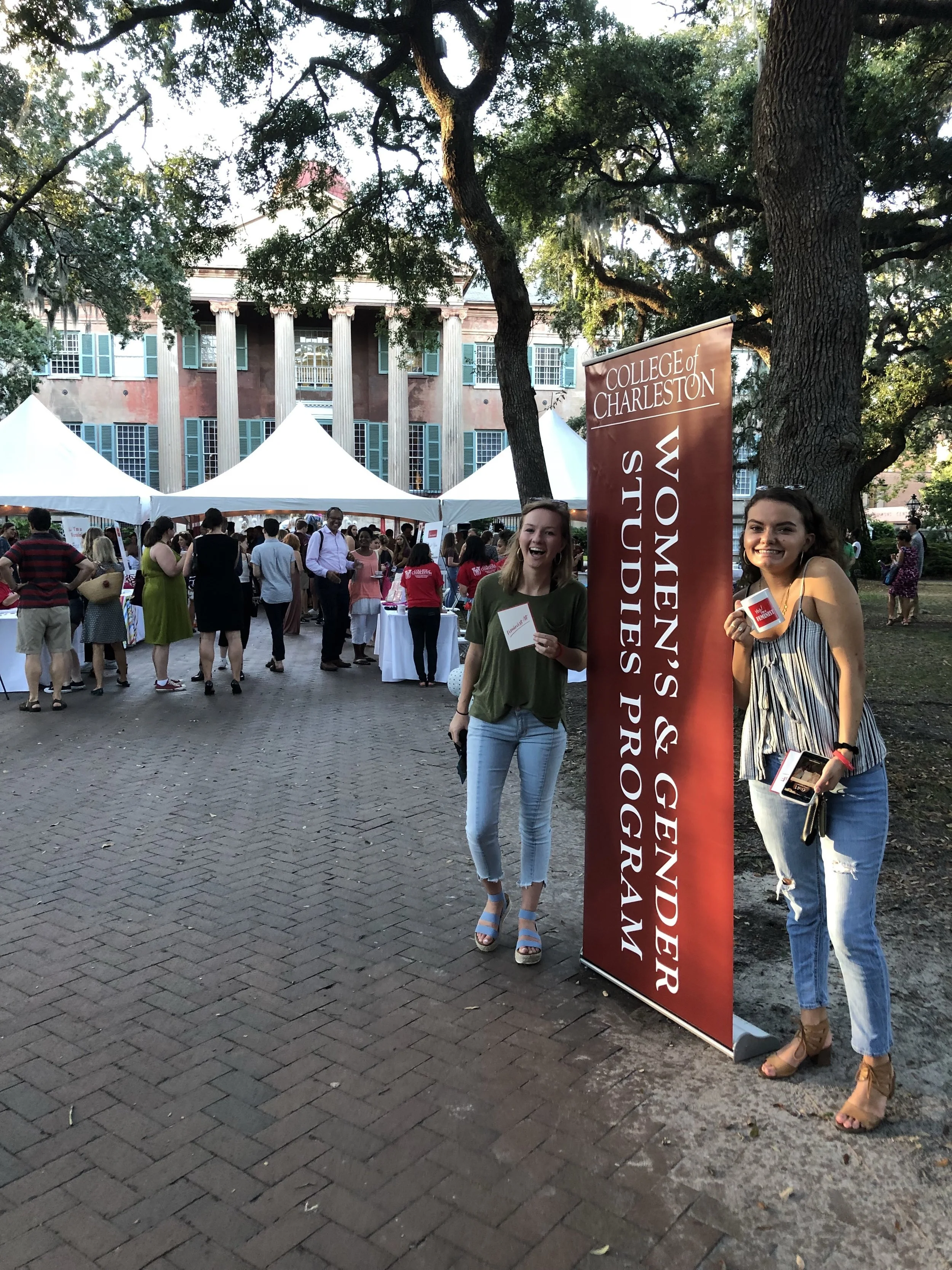 Julia and Jane standing in front of the banner at the Yes! I’m a Feminist event hosted in the Cistern Yard by the Women and Gender Studies program at the College. Photo credits to Grey Parsons.