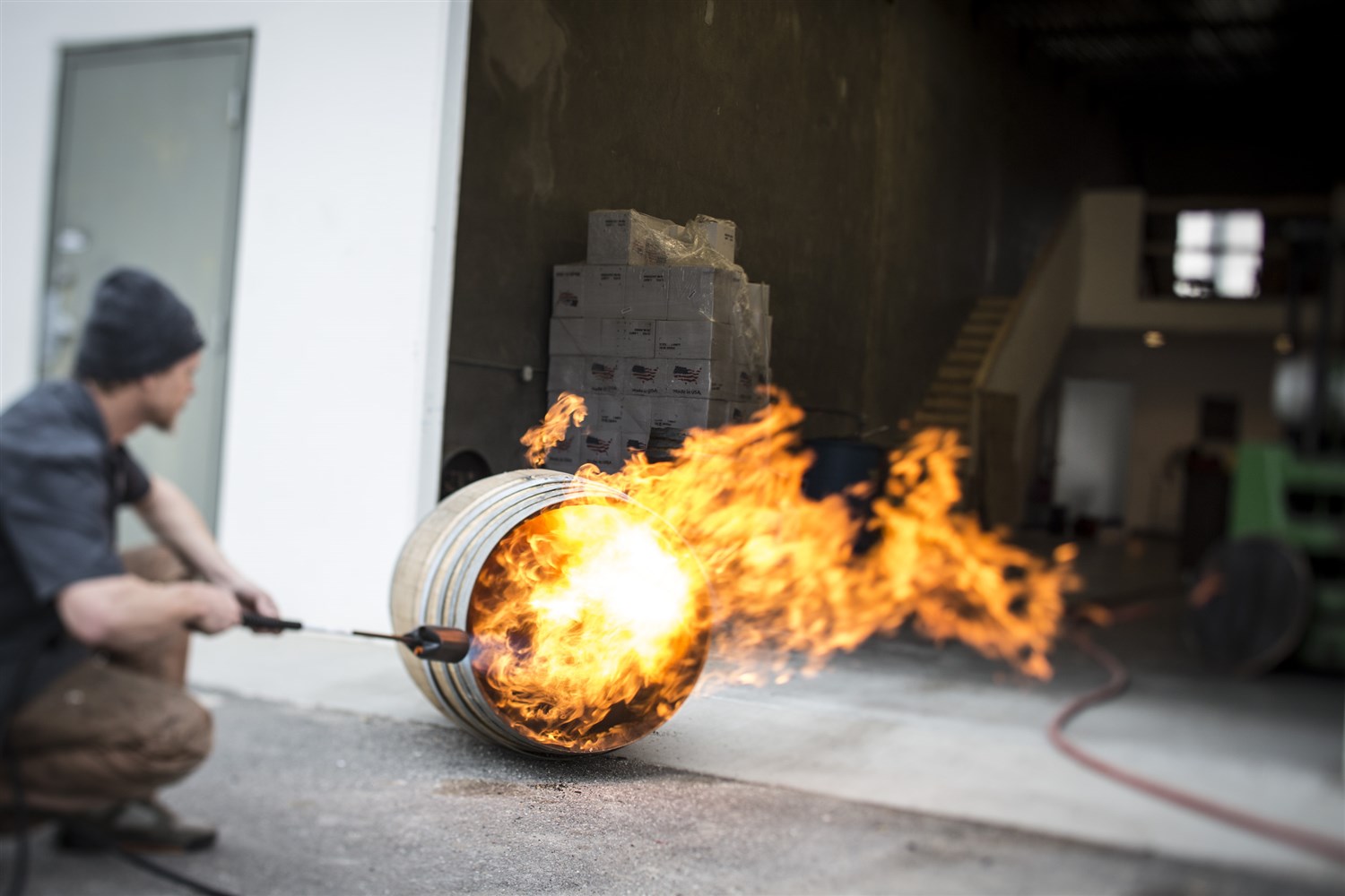 French Oak barrels previously used to cask wine (often chardonnay) are flame-charred with a tiger torch before being used to age gin. Courtesy Beehive Distilling