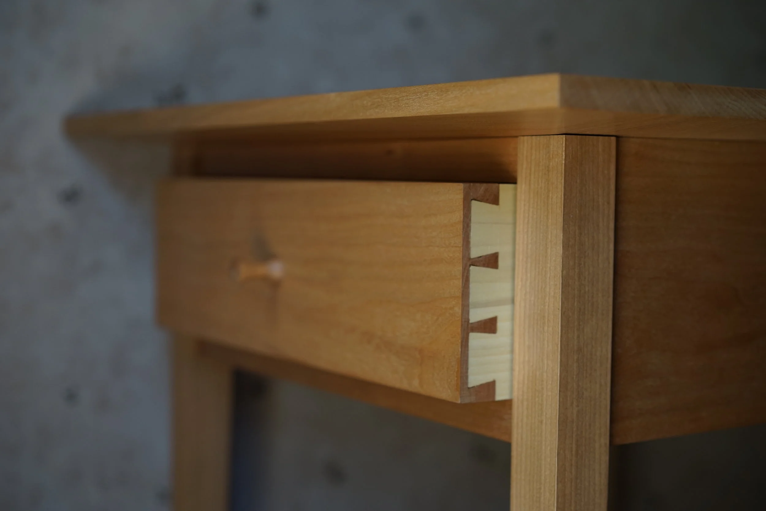  Traditional dovetailed drawer riding on wooden runners. 