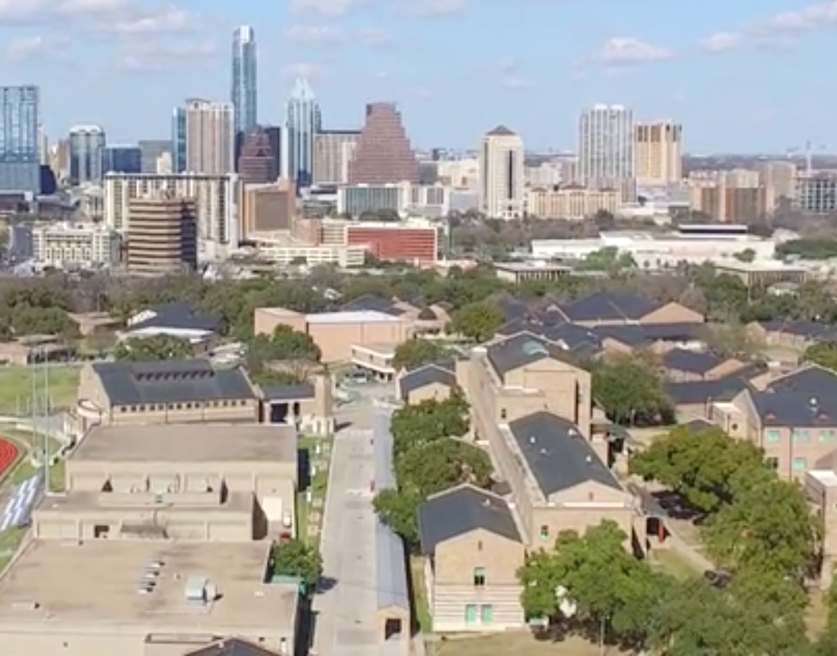 photo of the Texas School for the Deaf campus with the Austin skyline in the back