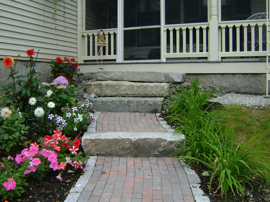 Aged granite and two tone brick create a beautiful entrance to a screened porch.