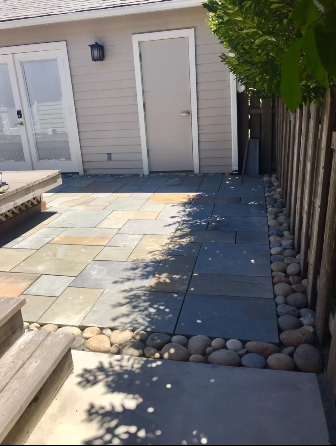 Blue stone patio with river rock border. Healdsburg, CA.