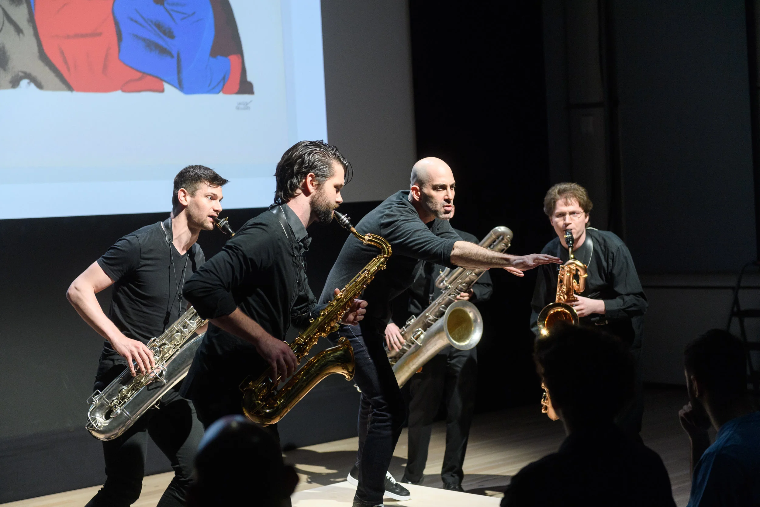 Performance at The Whitney Museum of American Art with ASL Slam Pictured (left to right): Thomas Giles (Baritone Saxophone), Cole Belt (Tenor Saxophone), Douglas Ridloff (Visual Poet), Ryan Mantell (Bass Saxophone), and Joshua Lang (Baritone Saxophone). 