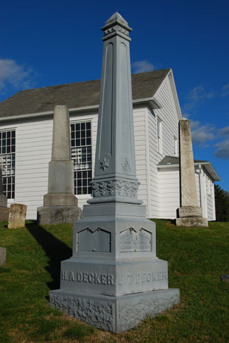 This is a metal obelisk which is in a class by itself. Ordered from mail order companies such as Sears & Roebuck, the cast iron had distinct advantages and disadvantages as a material for memorials. On the credit side they afforded durablity, easy and cheap manufacturing, and the freedom to create new designs, which was impossible to do in stone. Disadvantages included the essentially repetitive process of making them, and the difficulty of adding further lettering once the design had been cast.