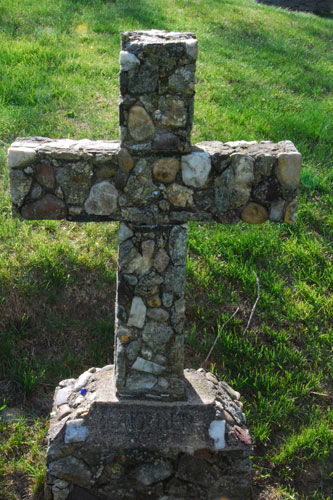 The most well known and loved of Christian symbols is the simple cross. It is a sign of salvation and hope and Christians believe that it has the power to defend them from evil. It represents Christ’s victory over death and sin. The handmade nature of this cross, using local cobbles, is unusual. At the bottom is etched “Mother.”