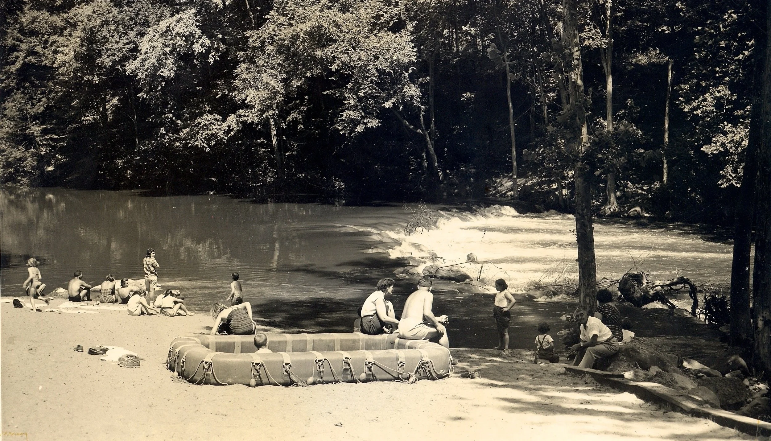 The beach area of today’s Silver Lake, shown in the 1950s before construction of the dam. The raft on the beach was usually anchored in middle of the river for the safety of swimmers.