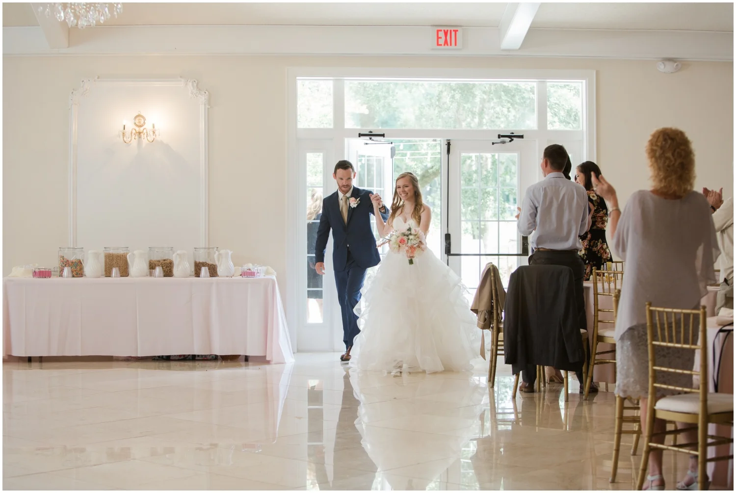 bride and groom entering their wedding reception