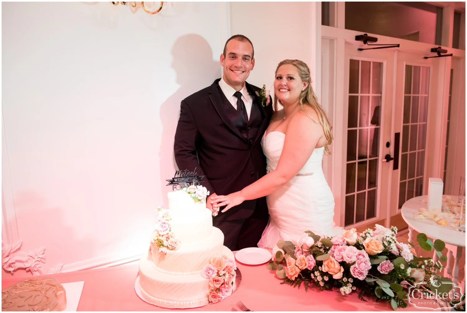 bride and groom cutting their wedding cake