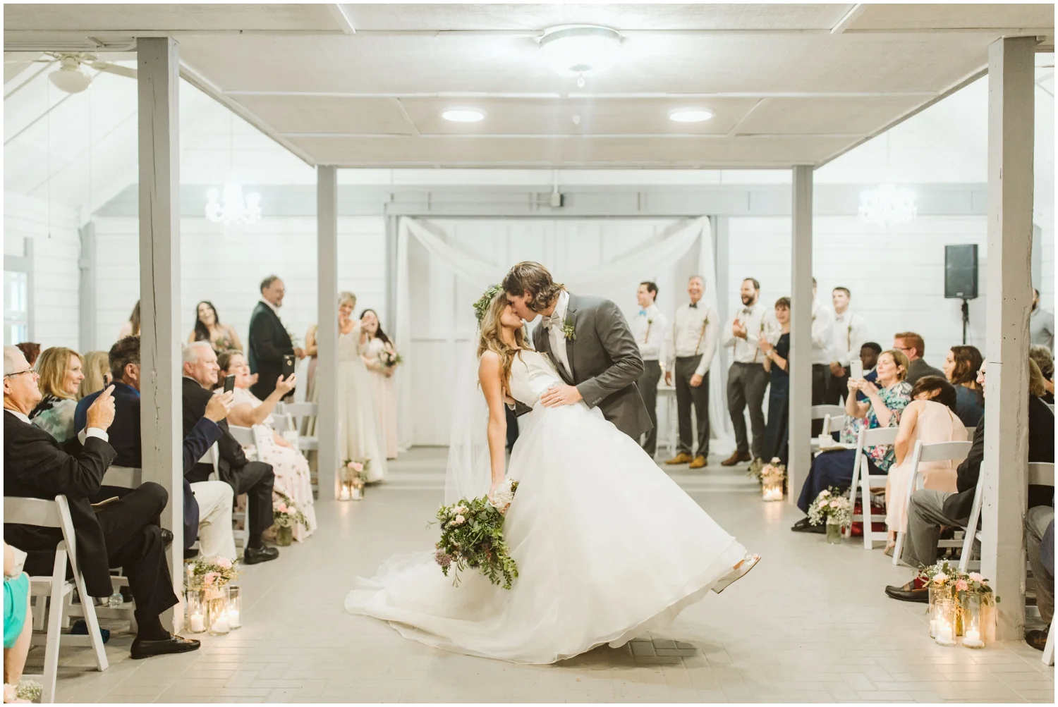 bride and groom kiss at their wedding ceremony