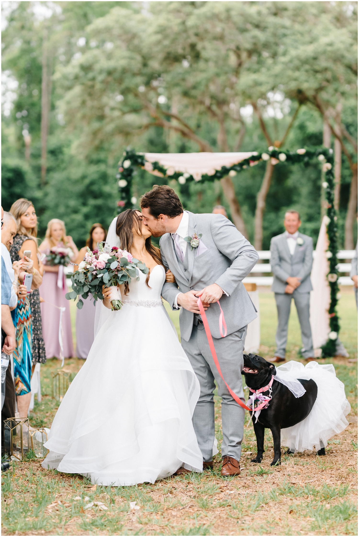 Bride and groom kiss at the wedding ceremony