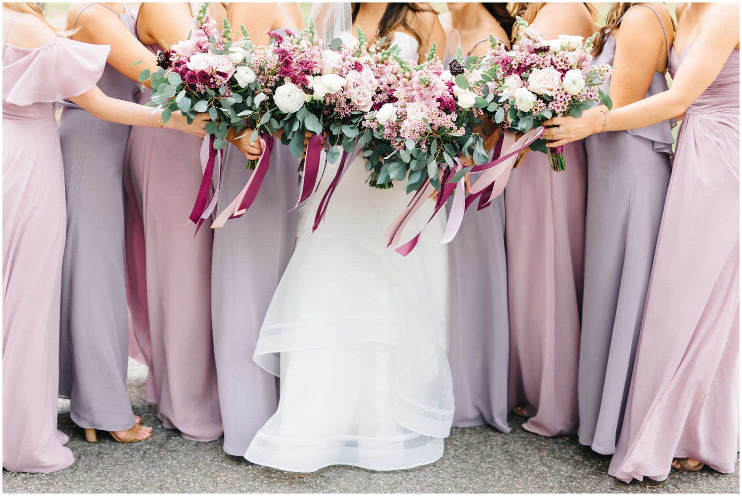 Bride and her bridesmaids holding wedding bouquets