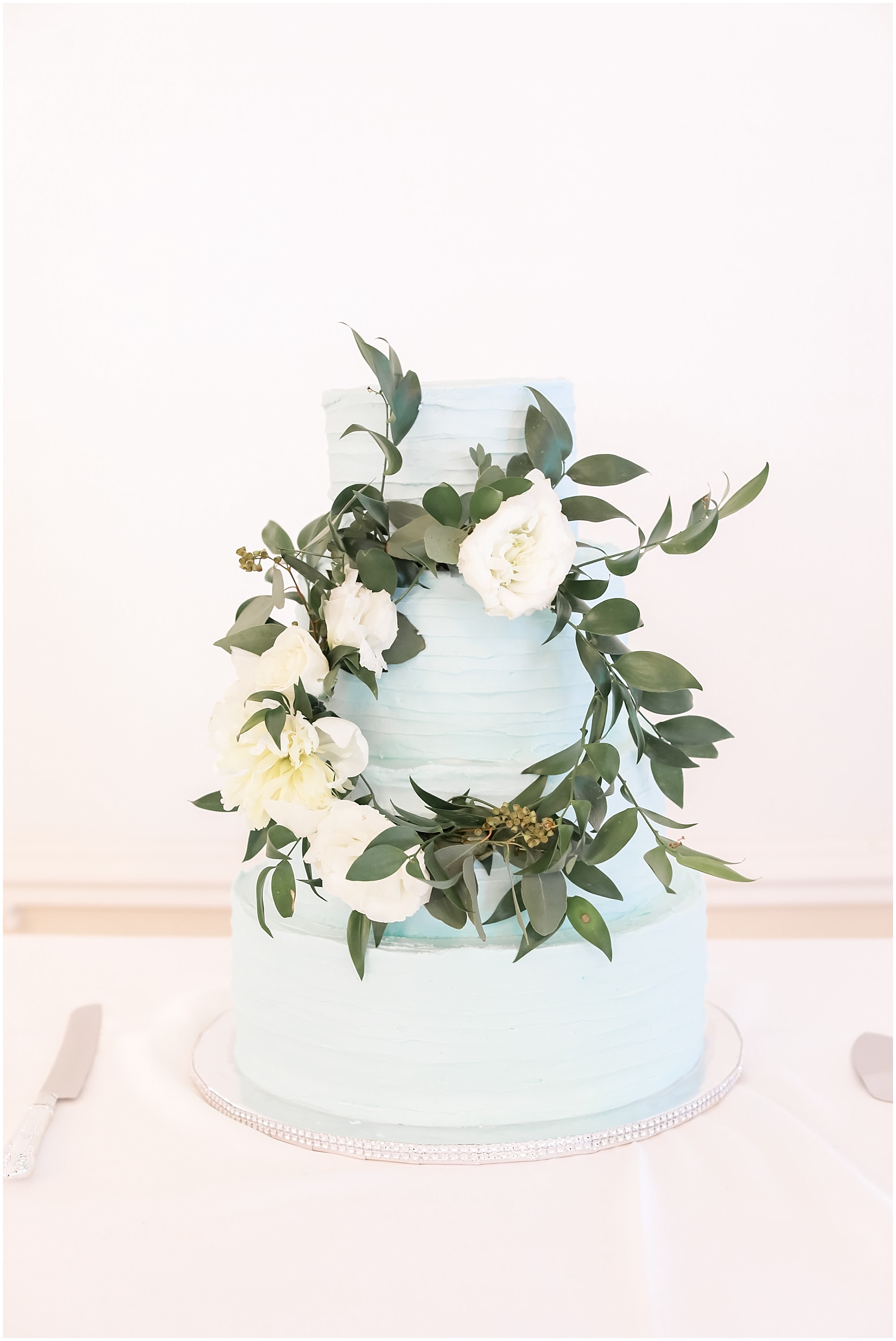 baby blue wedding cake with greenery decor