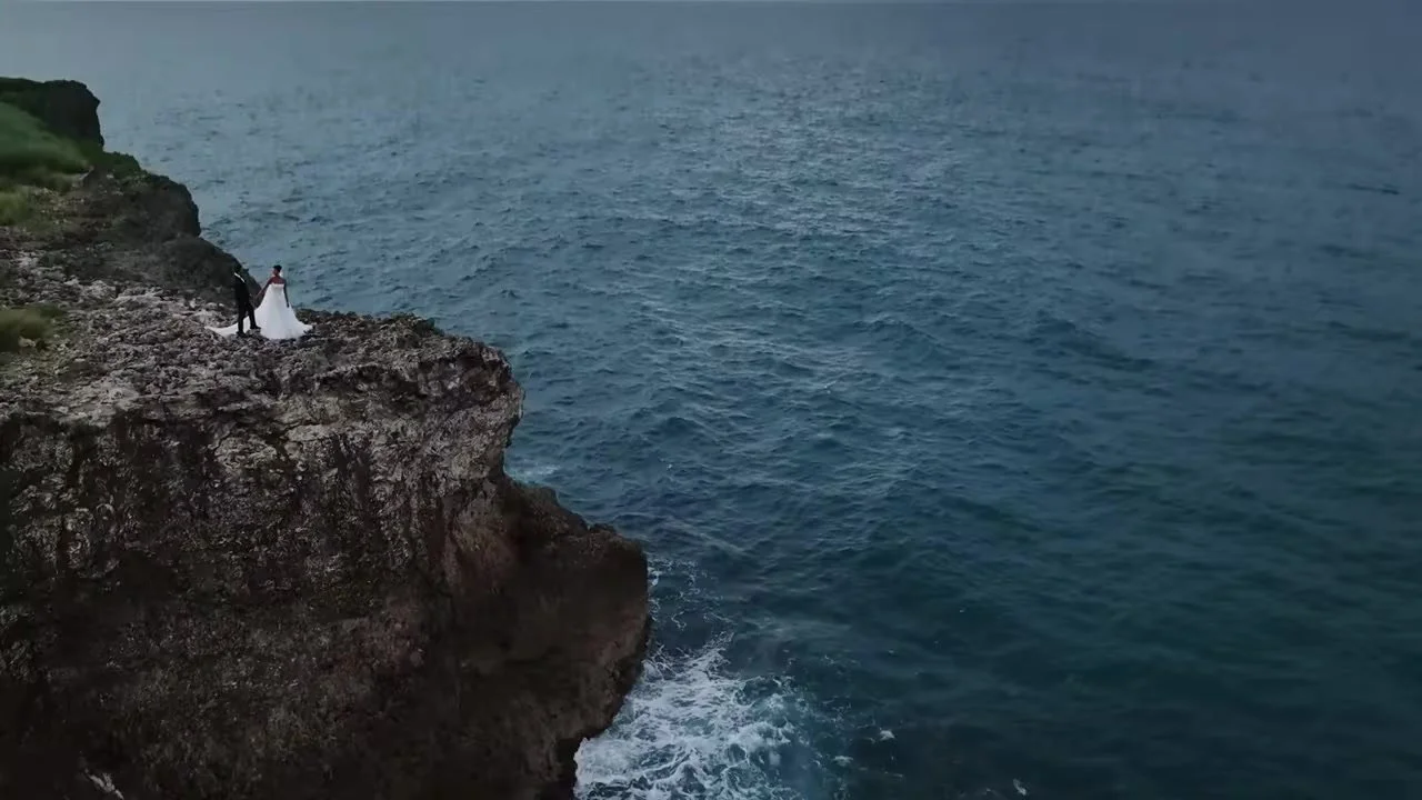 Daniela and Adam on the cliff edge above crashing Atlantic water