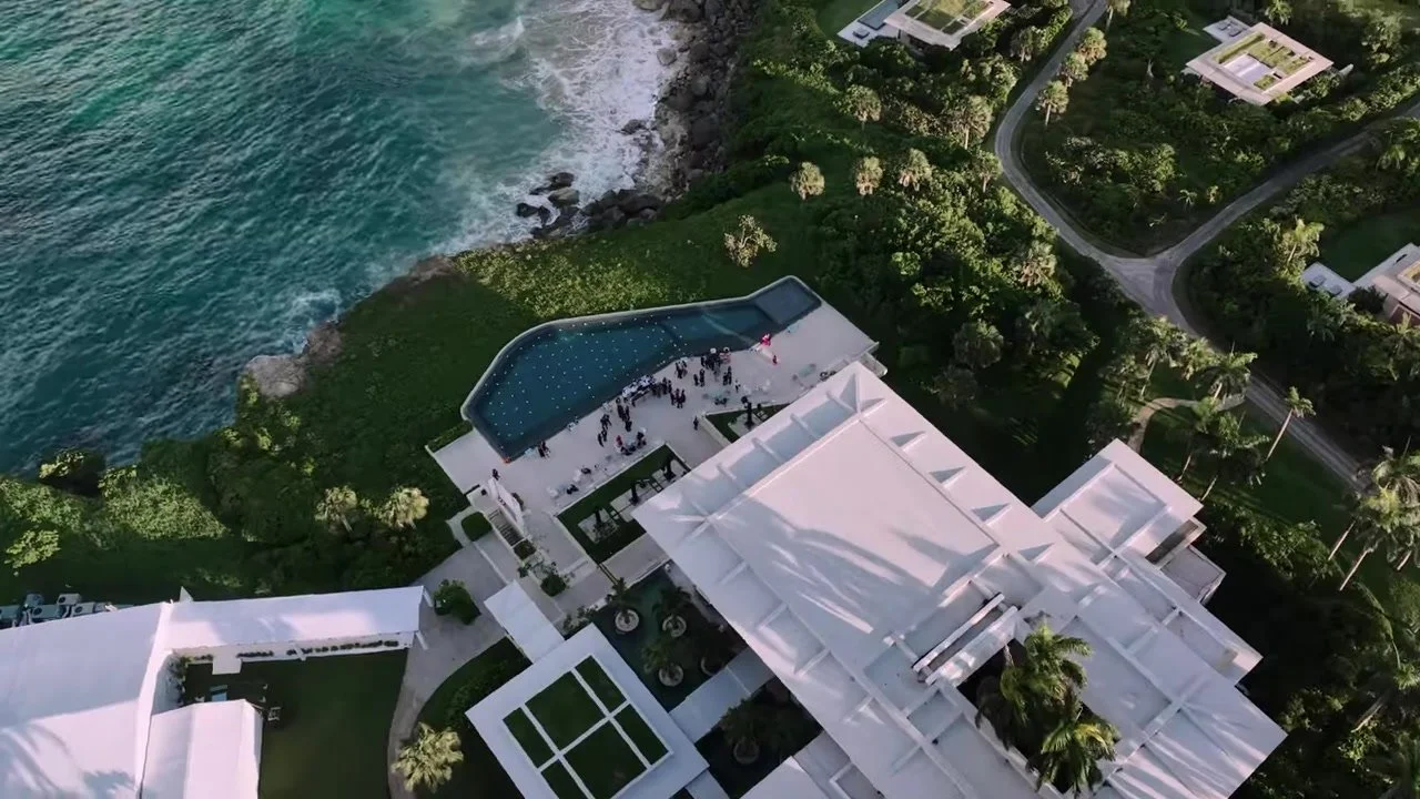 Aerial of the infinity pool terrace packed with wedding guests