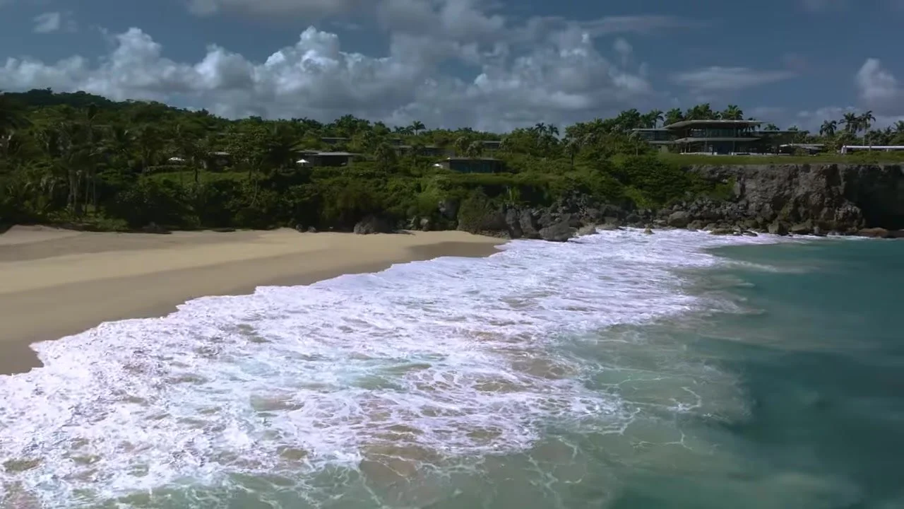 Wide coastal view of Playa Grande, jungle, and modern Amanera villas