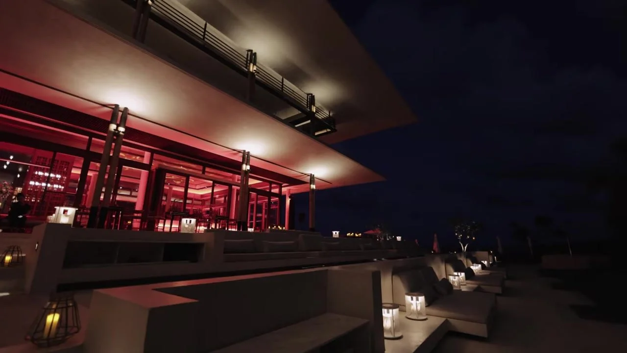 The Amanera villa glowing red at night with lanterns on the terrace steps