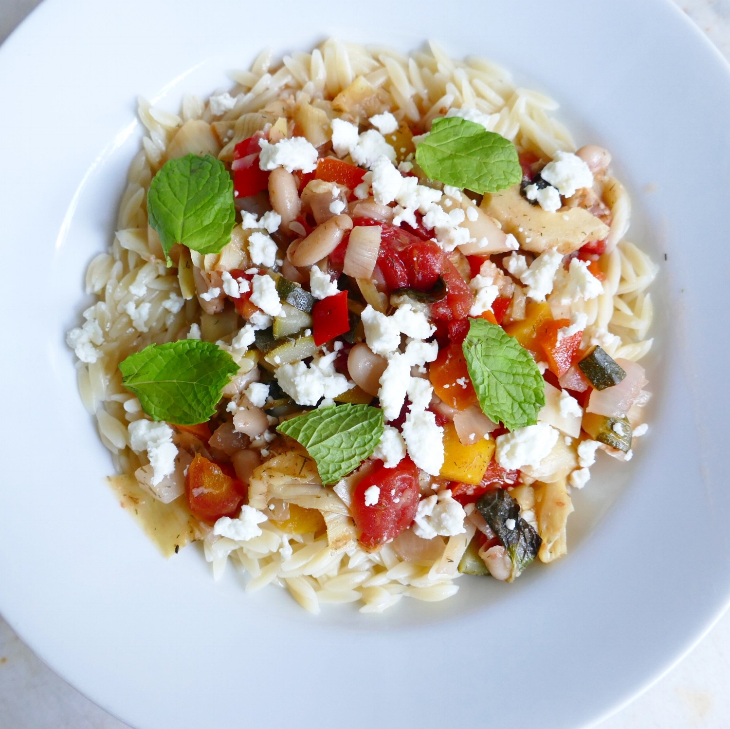 Greek Lemon-Mint Beans and Vegetables Over Orzo Topped with Feta