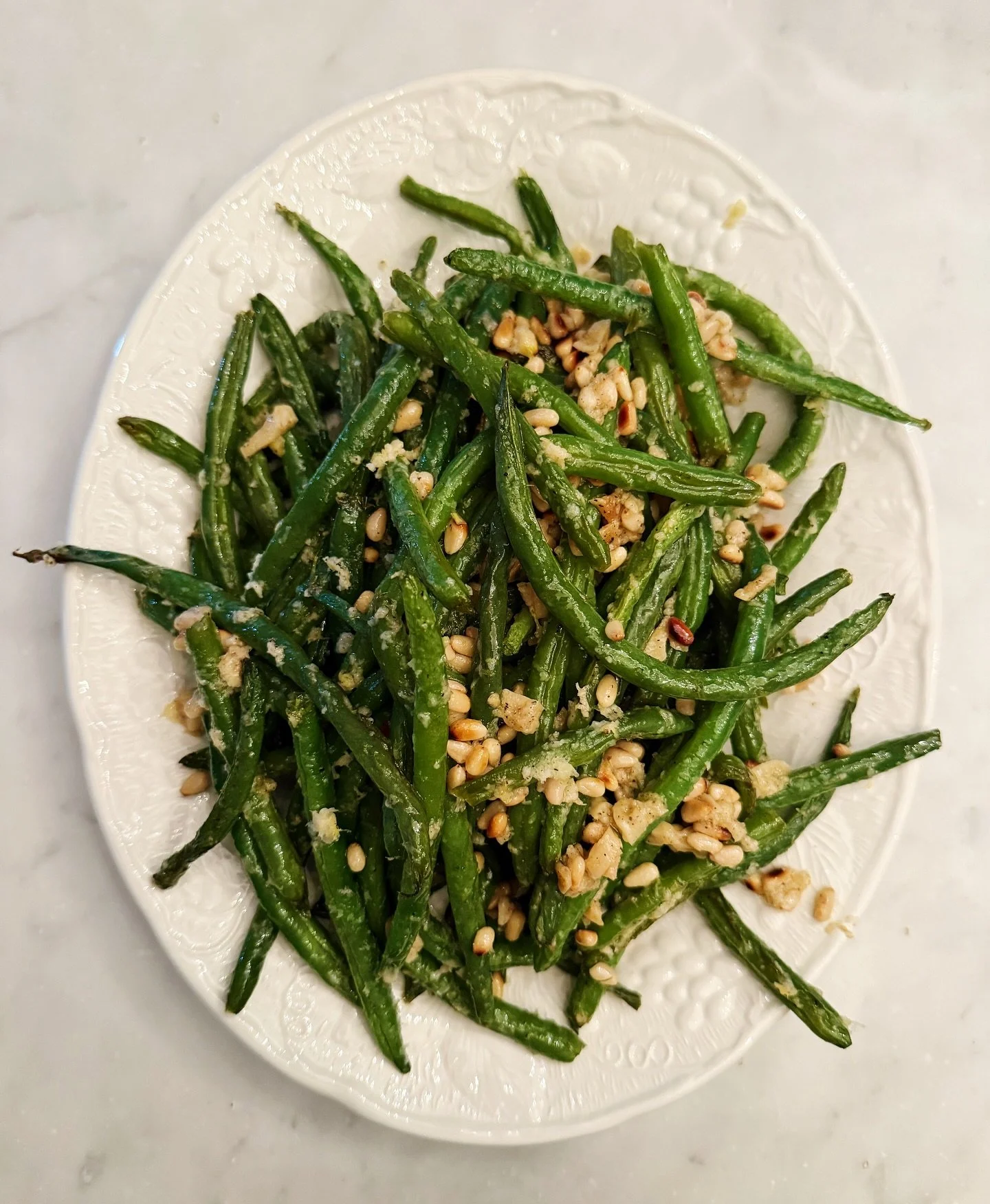 Roasted Green Beans with Garlic, Lemon, Pine Nuts, and Parmesan

Every Thanksgiving I make one new dish and this was it this year. I made it the day before because it said you could and I have enough going on today this seemed an appealing idea. Whil