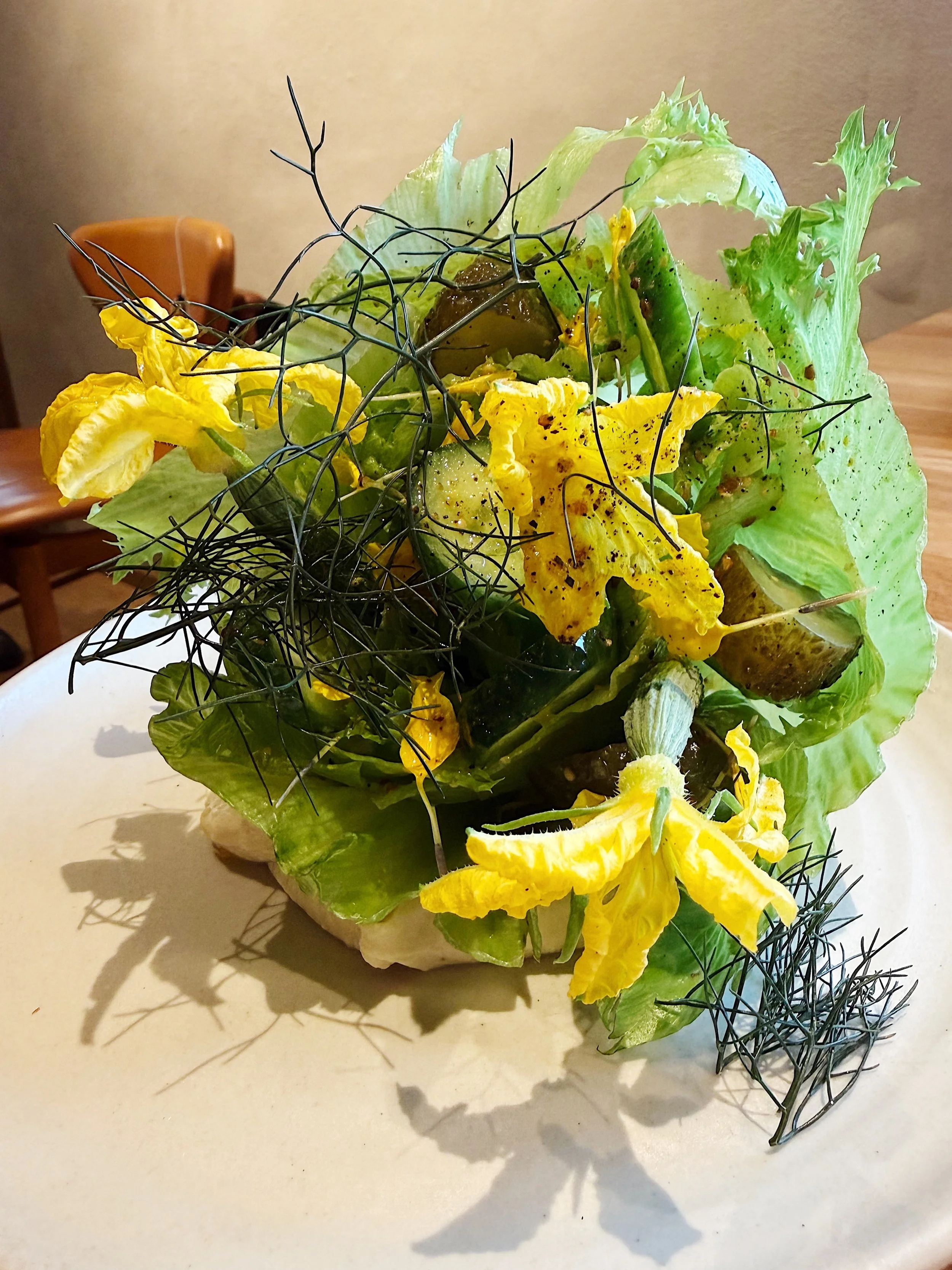 The Green Salad

@barrcph 
A moment for this gorgeous salad. Almost too pretty to eat. A sculptural weaving of lettuce, pea hummus, pickled cucumber and sweat flowers topped with a mustard vinaigrette. Our  whole meal at this restaurant was the peak 