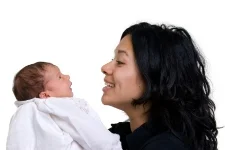 Mom looking at baby; speech and language devlopmental milestones at Canto Speech Therapy Online