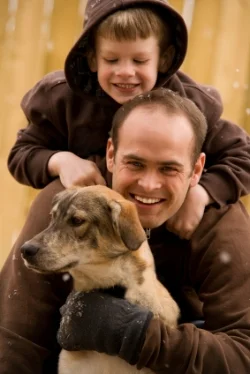 Dad with boy and dog, talking; language development at Canto Speech Therapy Online