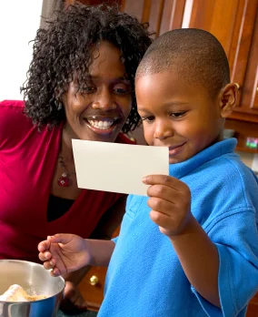 Mom and boy reading recipe; strong phonological awareness ensures good reading skills at Canto Speech Therapy Online