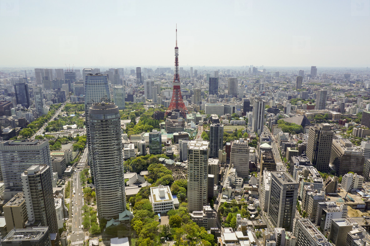 Aerial view of Tokyo Tower in city against sky on sunny day, Tokyo, Japan. Photo by Marc Volk.