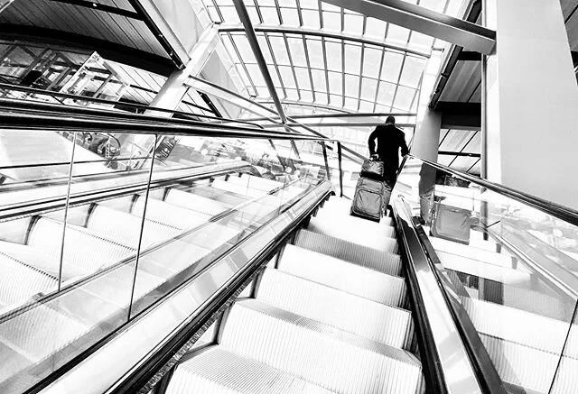 Traveler 🧳 ✈️ #blackandwhite #photography #headingup #lookingup #airport #stairs #contrast #ruleofthirds