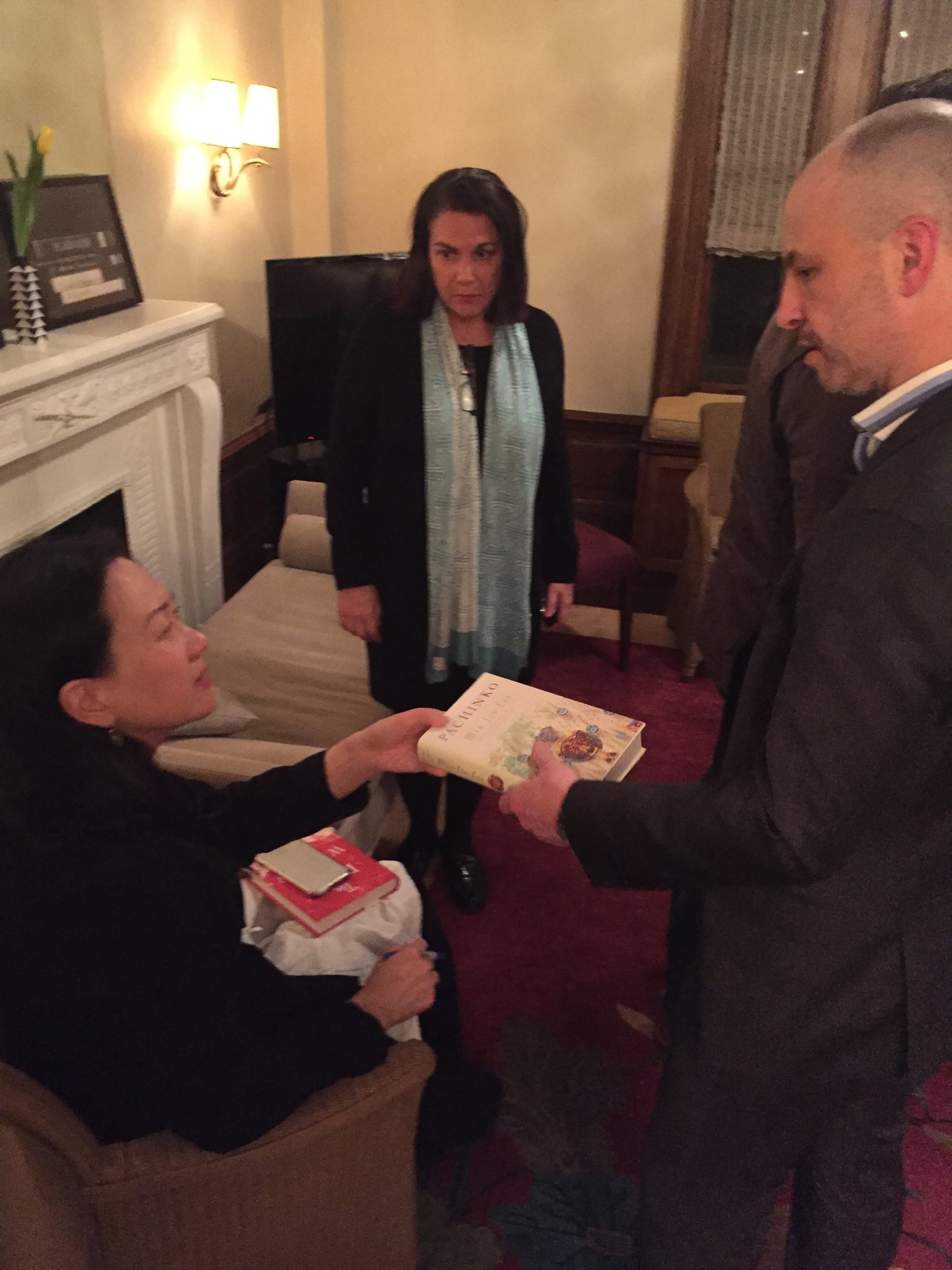 Min Jin Lee signs a copy of PACHINKO