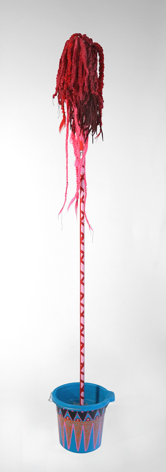  "Mop 2”, from the Series Whips, Whims and Wigs, 2019, Transformed mop head into a hairdo on &nbsp; decorated stick, various materials. 