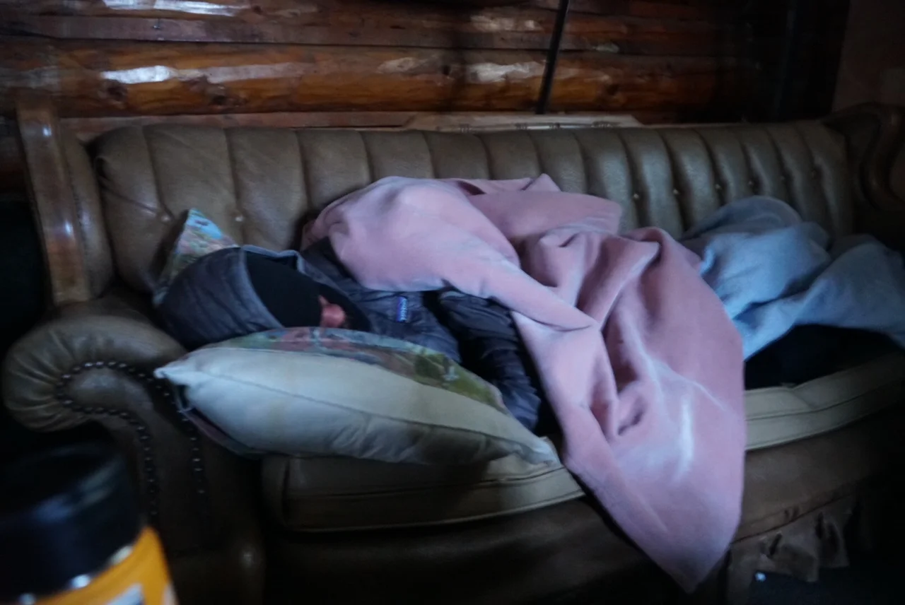 John Logar grabs some shut-eye in the Rainy Pass Lodge cabin