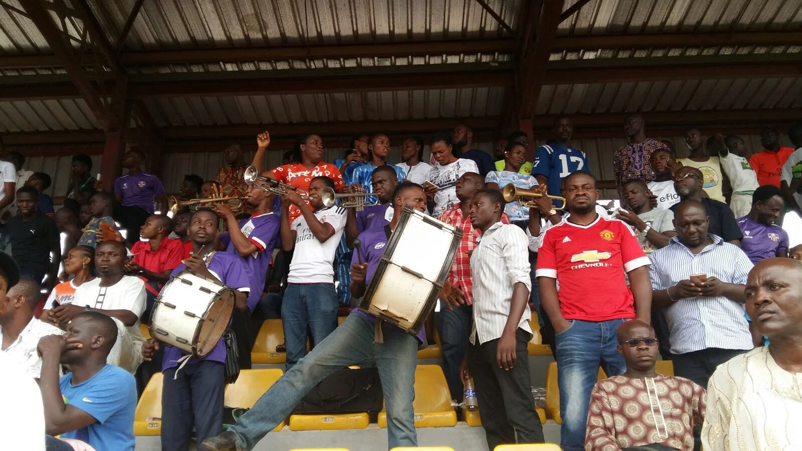 A brass band, comprised of football fans, plays in the stands at Agege Stadium. Photo by David Goldblatt. 