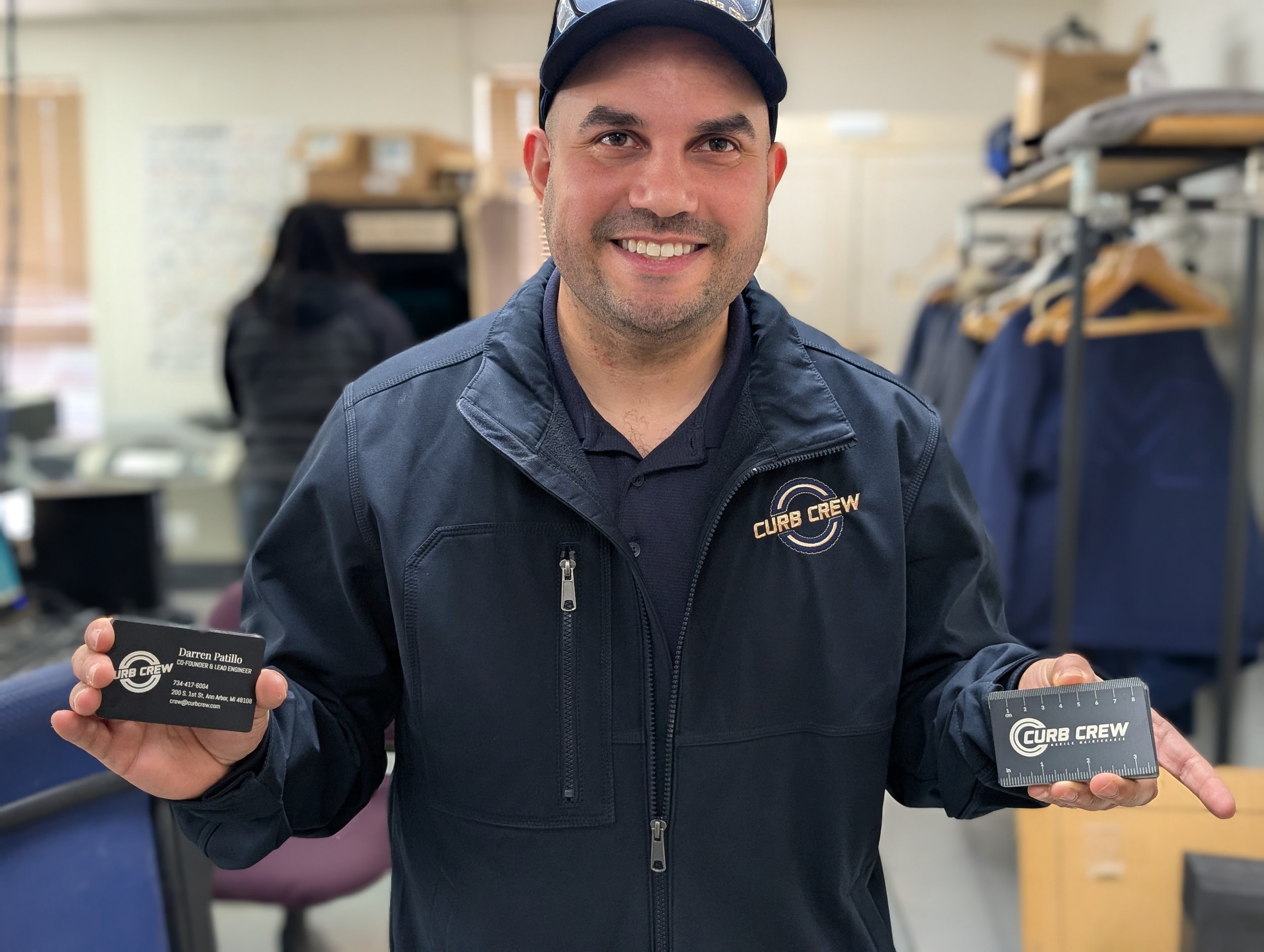 Picture of local business 'Curb Crew' holding up their just laser engraved metal business cards