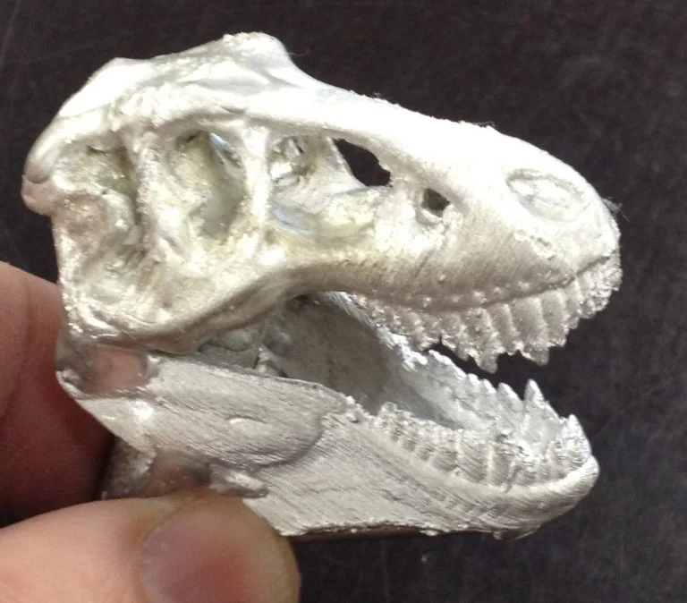A pewter T-Rex skull. Every flaw–that is, detail–was captured faithfully.