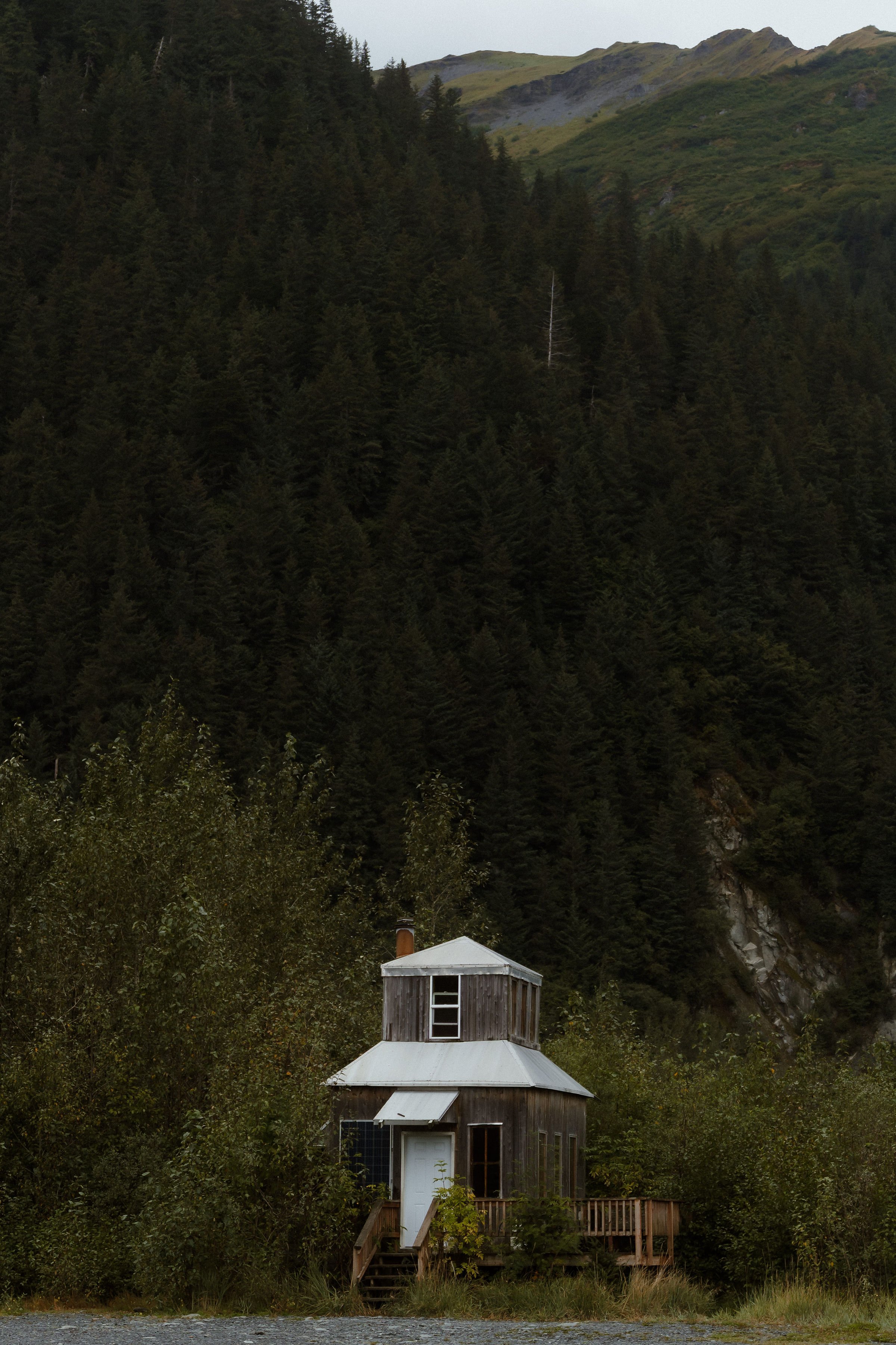 Madelynnmae-Millers-landing-cabin-under-towering-mountains.jpg