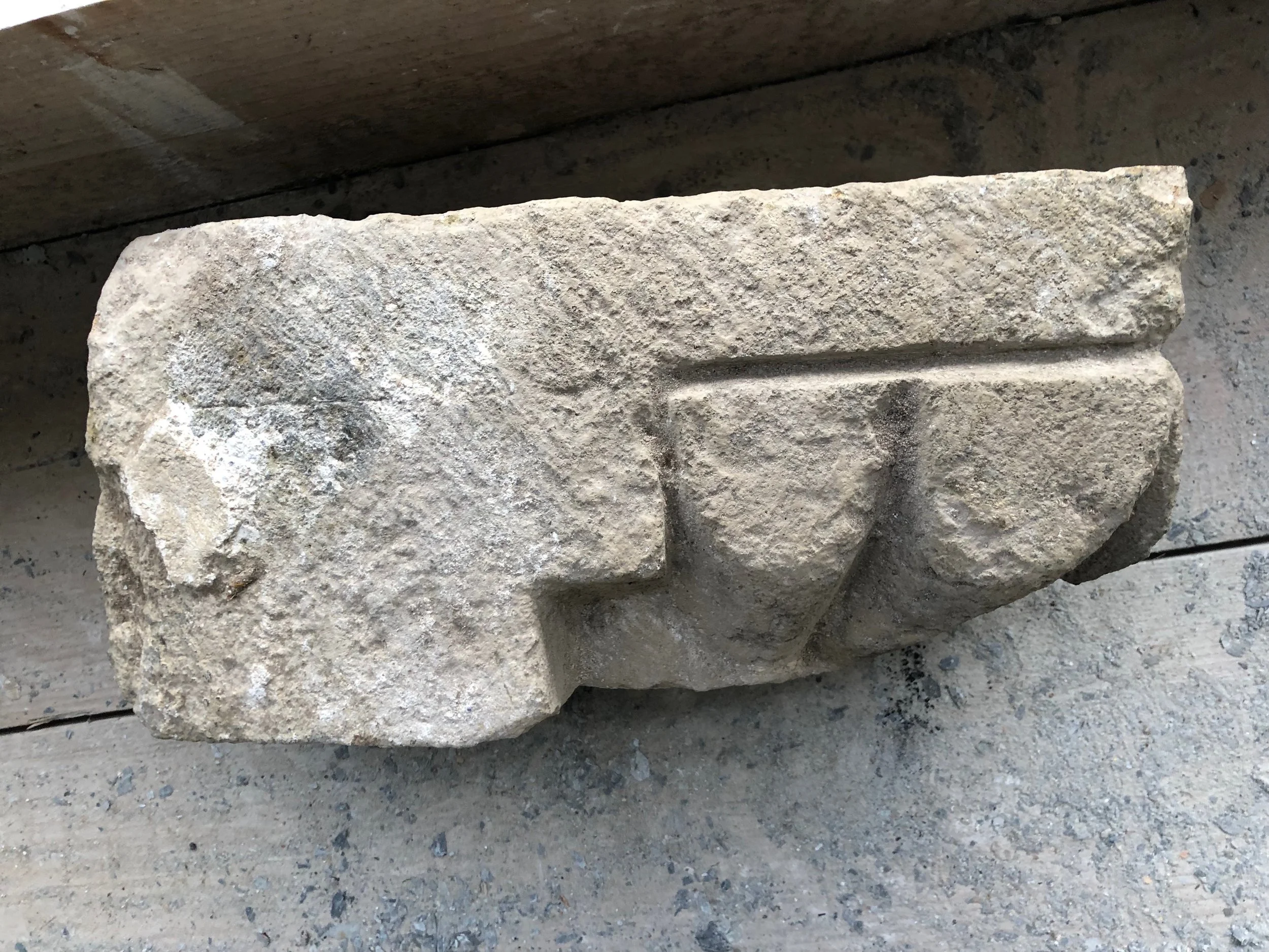 early capital for a door pillar with a small piece of plaster left on it. probably dating from around 1150 AD