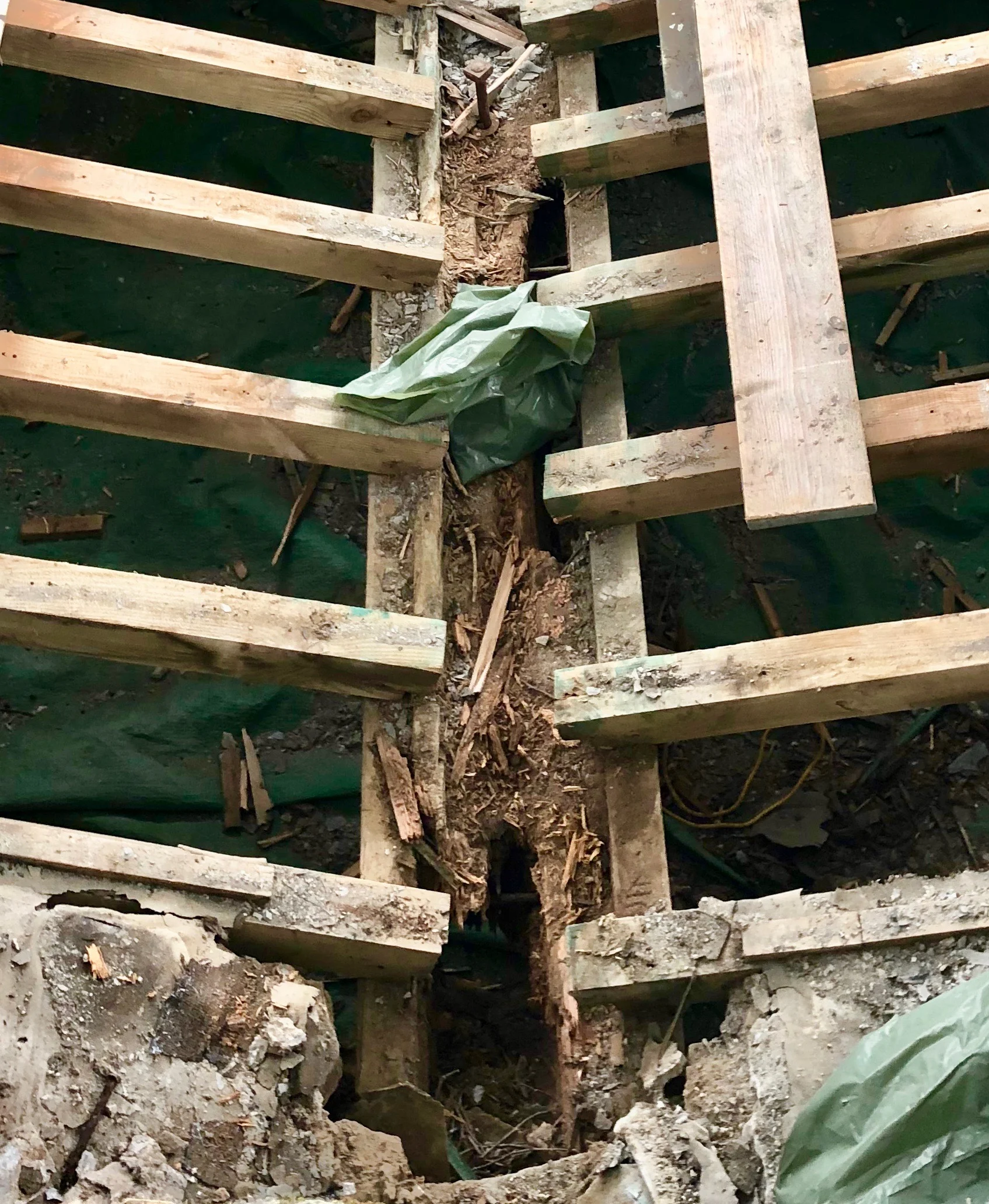 looking down on the tower roof with slates removed you can see that the main suppot beam is completely rotten