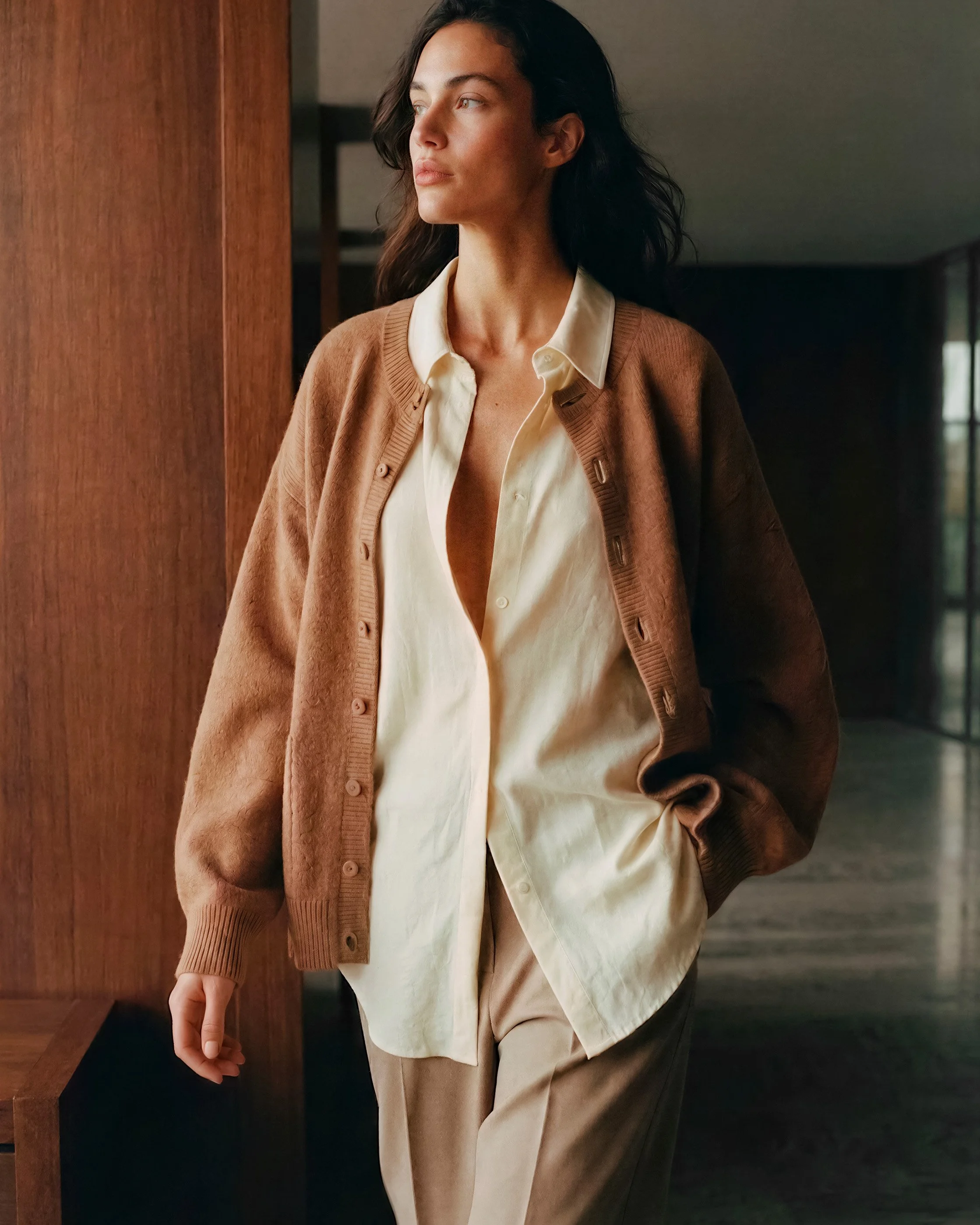 woman walking in luxury hotel lobby in casual outfit