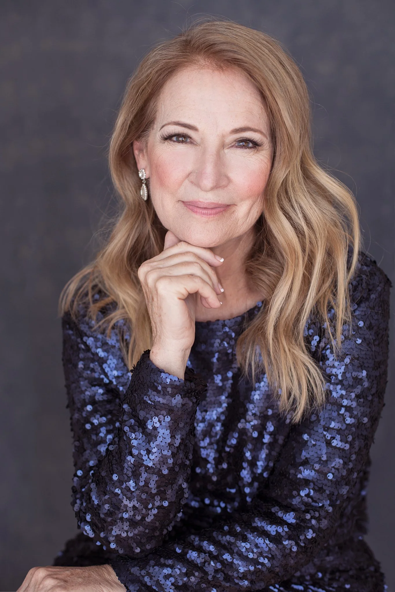 Woman in a navy sequin dress during a guided studio portrait experience.