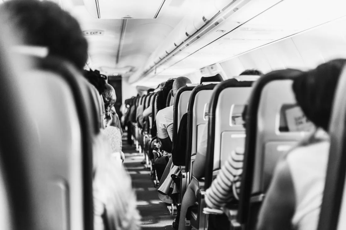 An airplane aisle looking forwards