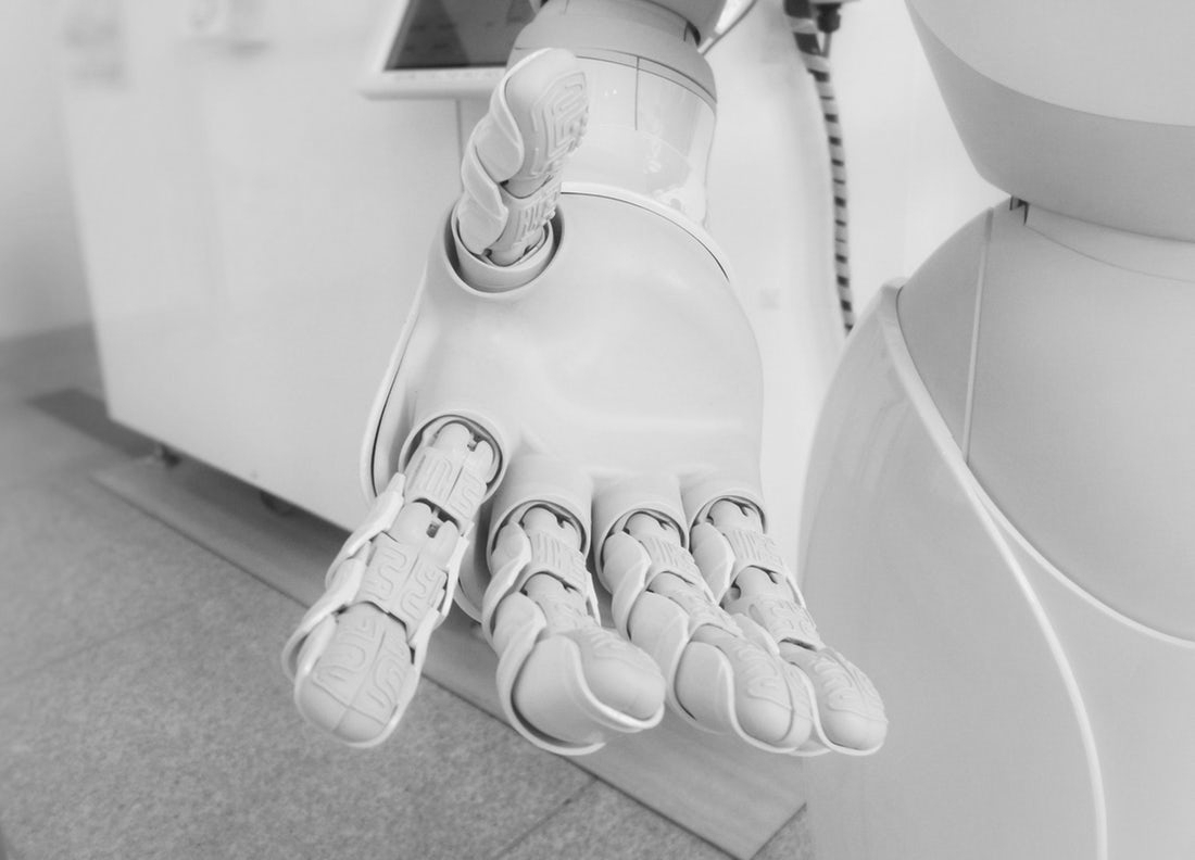 A robotic hand reaches towards the camera