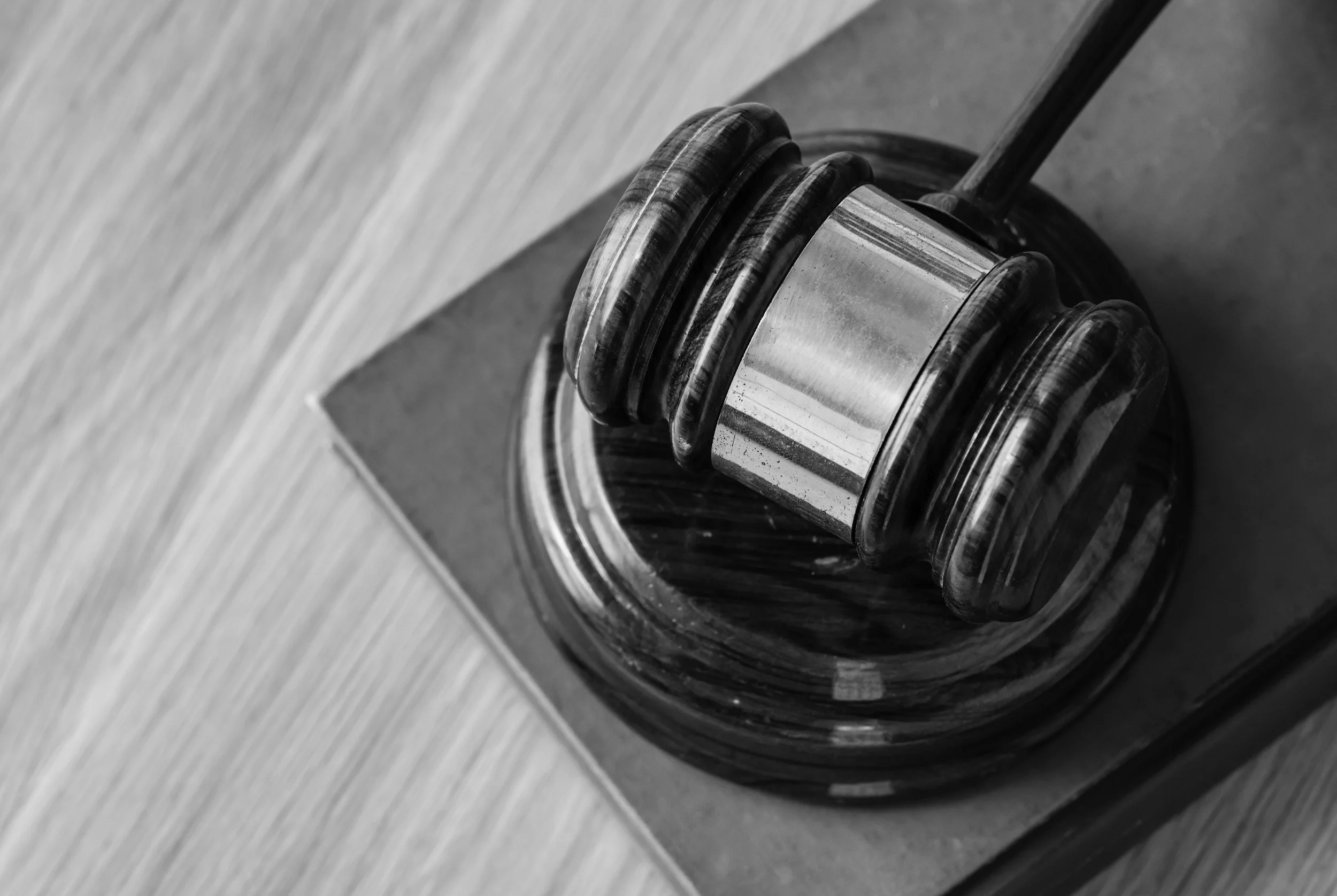 A gavel resting on its block