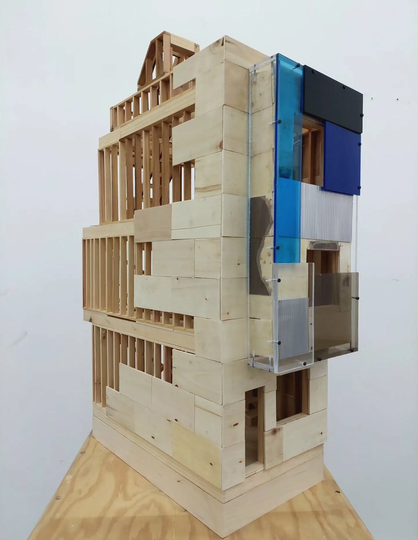 Finally finished this model of a box new rowhouse. Getting the siding right for the bump-out was a journey- I tried laminate, miniature corrugated metal, painted chipboard. Finally decided to let the glue and torn materials stay behind and frame it a