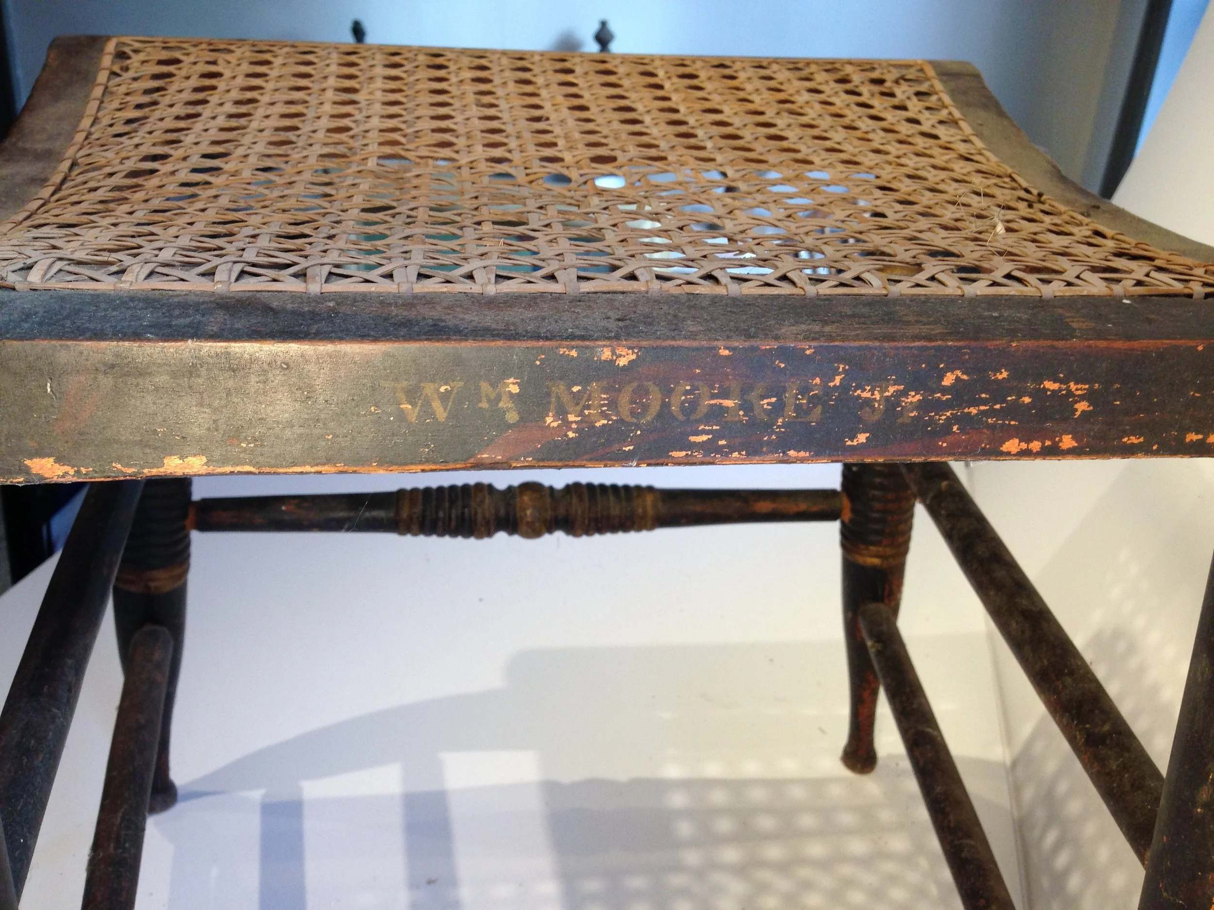 "William Moore Jr." stenciled on back of chair seat.