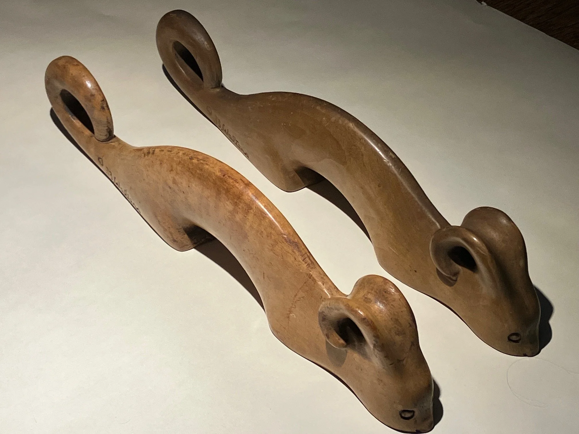 A pair of carved wooded creatures, 18 inches long, 1933