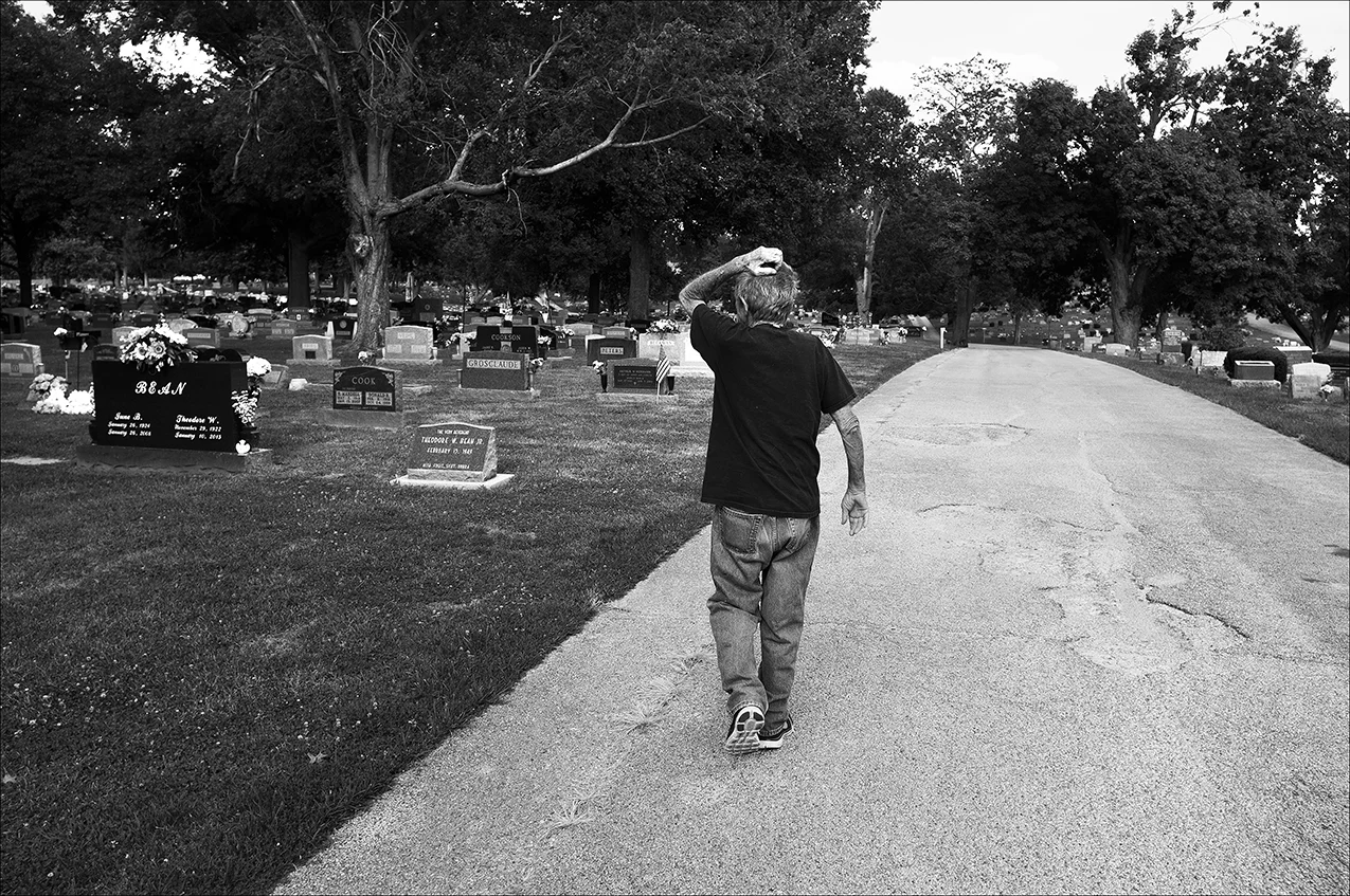 July 2017: Clarence searches for Vickie’s burial plot in Green Mount Cemetery in Quincy. He’s heard Vickie’s remains may have been placed next to her parents’ grave, but thus far he’s been unable to find her. “Clarence just sits on the front porch mostly. He cries every day, missing Vickie,” Brenda says of Clarence, who was very active before her death.